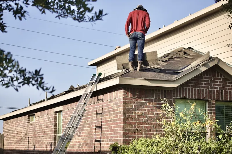Professional roofer working on a residential roof in Mount Airy Village West